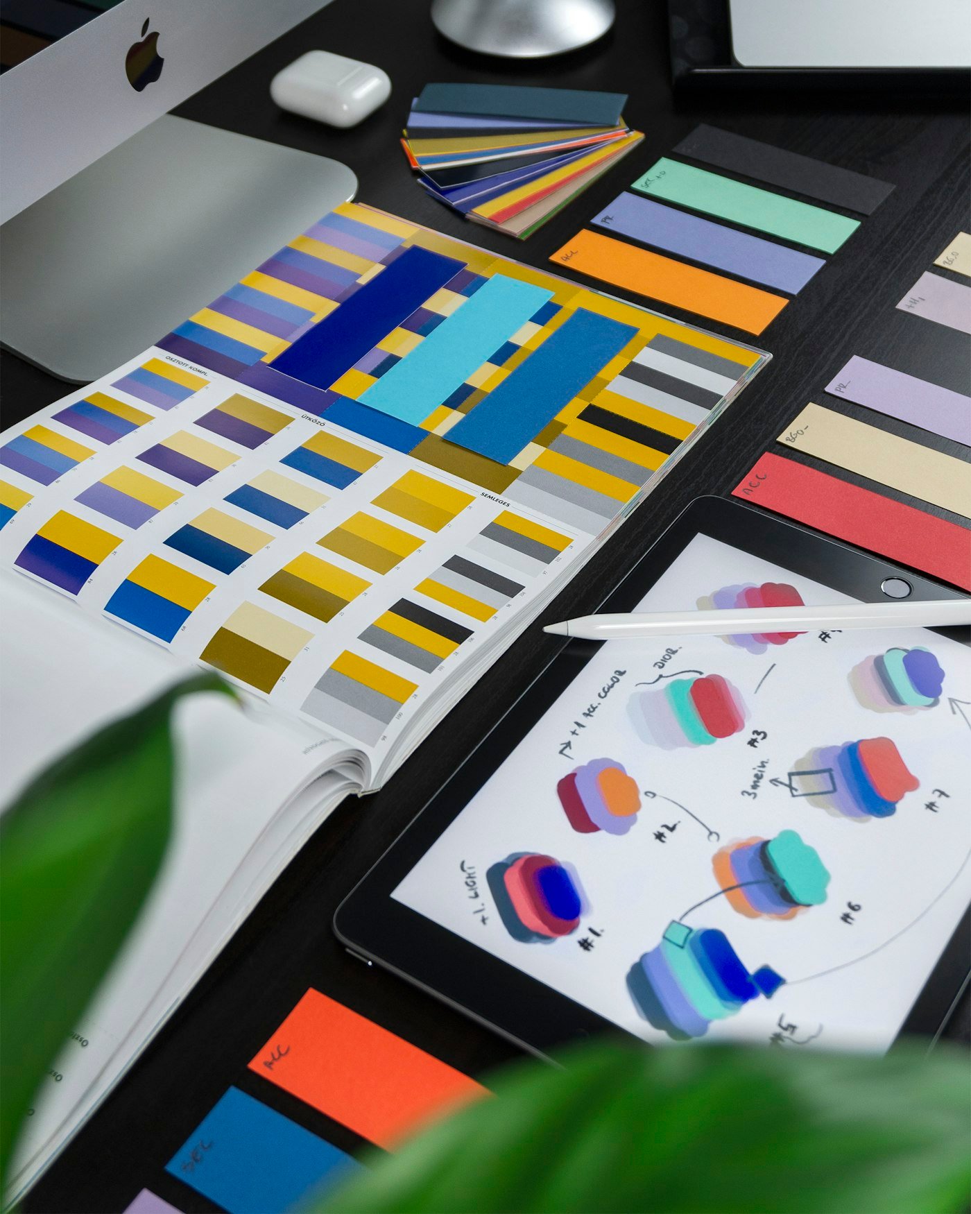 Creative desk with design tools and color samples