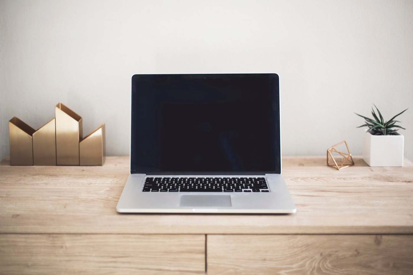 Laptop on a wooden desk for daily typing benchmarks